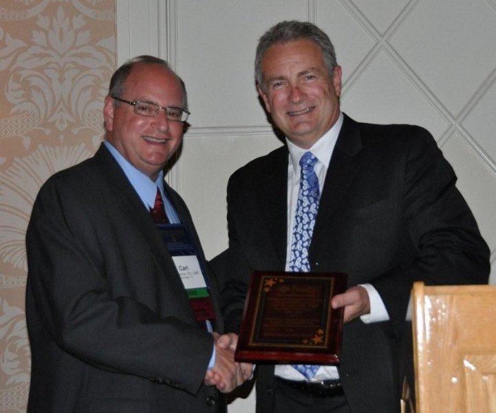 FMDA- Oct. 2011 138.jpg - Dr. Carl Suchar (left) is presented with a plaque for his dedication and work as Chairman of the Board of FMDA over the past two years.